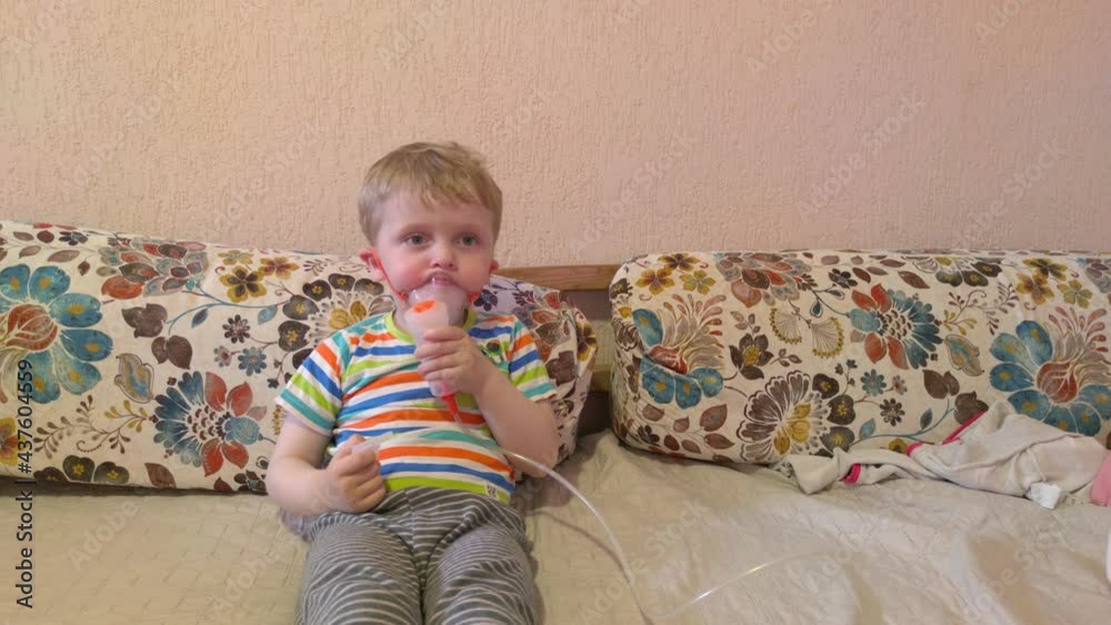 Boy breathes with inhaler home treatment Boy breathes with inhaler home treatment
