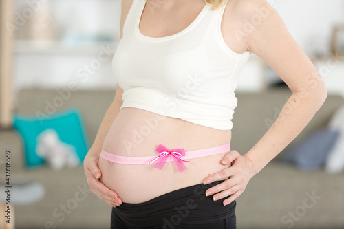 Free Download pregnant woman with pink ribbon on the white - GFXLoad