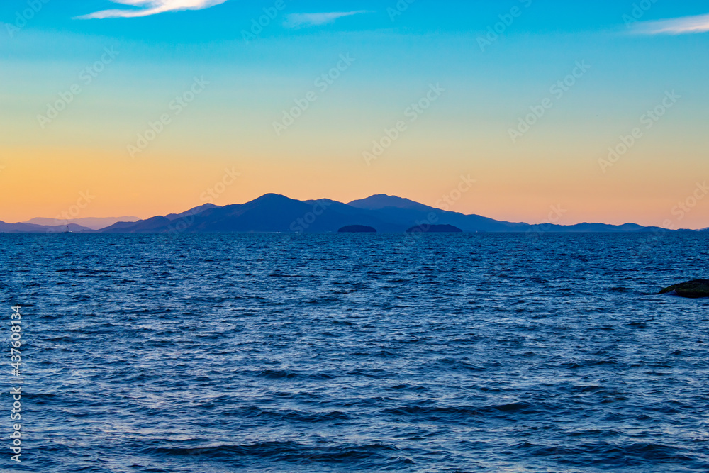 sunset in the sea n the city of the Florianopolis city, Hercílio Luz bridge, Florianópolis, Santa Catarina, Brazil