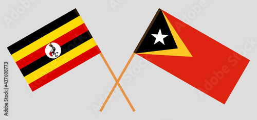 Crossed flags of Uganda and East Timor. Official colors. Correct proportion