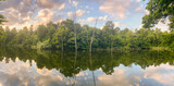 Panorama of sunset on the lake with submerged trees