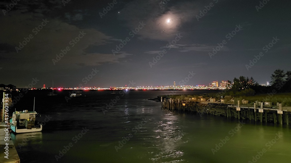 night view of a city with harbor and moon (Saratoga street)