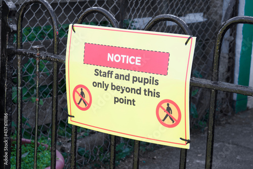 Social distancing sign at school playground road crossing photo