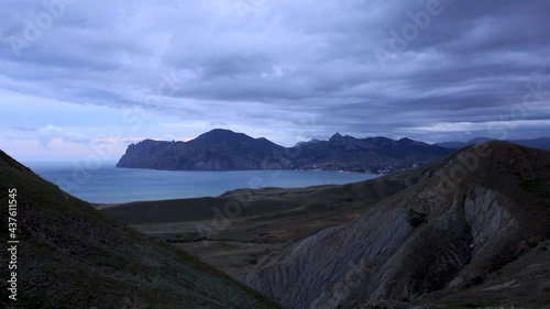 The movement of clouds over the volcano Karadag, Koktebel Bay and the village of Koktebel, Black Sea, Crimea. Timelapse photo