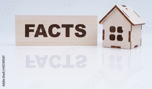 There is a wooden house and a sign on the table - facts