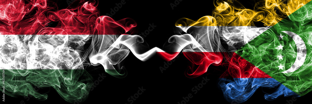 Hungary, Hungarian vs Comoros, Comorian smoky flags side by side. Hungary, Hungarian vs Comoros, Comorian smoky flags side by side.