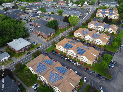 aerial view of apartment buildings with solar panel installed on roof 
