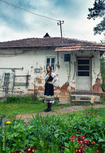 A young woman is posing in a traditional Serbian handmade outfit Litak (narodna nošnja Litak) photo