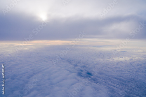View from the window of a passenger plane during the flight. Clouds from above.