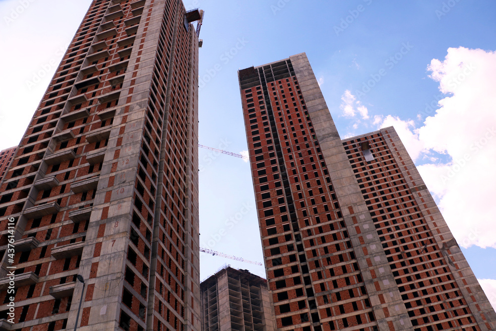 selective focus Tall buildings and blue sky. turkey istanbul's new buildings under construction reaching the clouds