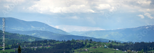 Panorama of the Carpathian mountains in the snow on a spring day