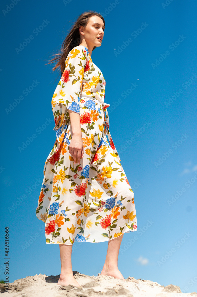 Young woman on the beach wearing pareo Young woman on the beach wearing pareo