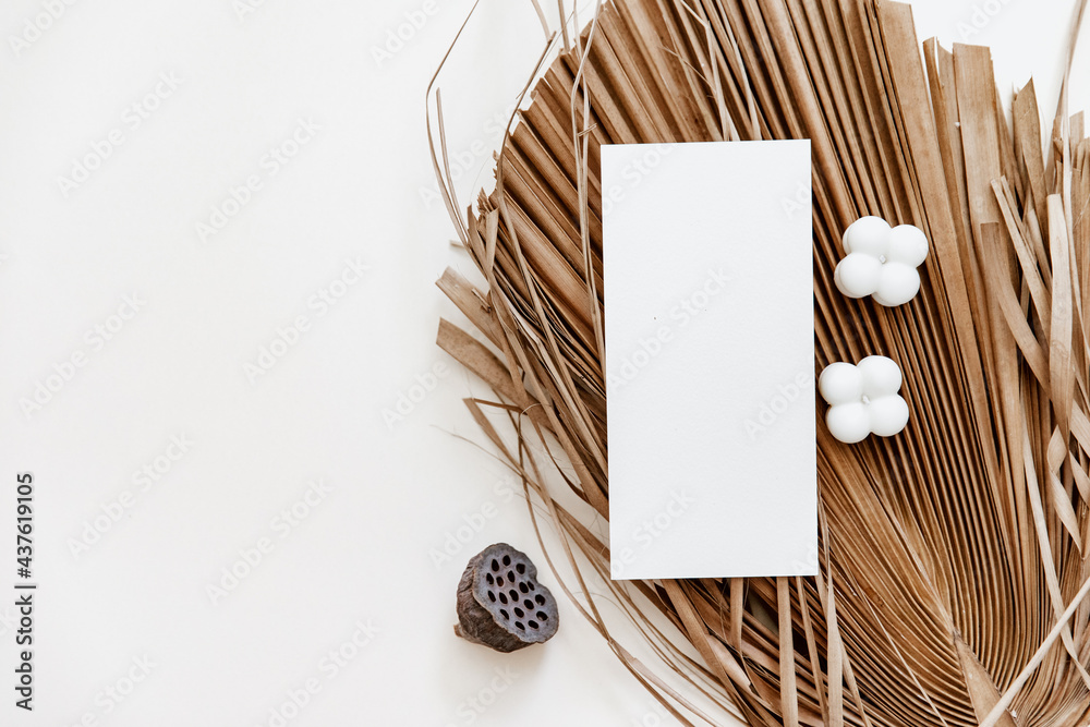 Summer stationery minimal mock-up. Blank card, palm leaves, beige textured table background. Wedding mock up. Flat lay, top view Summer stationery minimal mock-up. Blank card, palm leaves, beige textured table background. Wedding mock up. Flat lay, top view