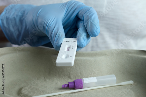 close-up of a male medic's hand holding a test cassette, medical disposable sterile test kit for rapid test covid-19, concept of early detection of viral disease, SARS-CoV-2 epidemic, coronavirus