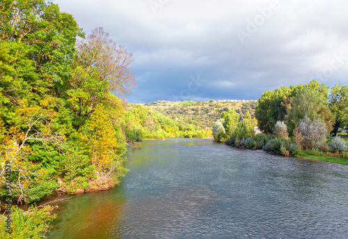 Tarn River in Millau France . River flowing through rolling hills