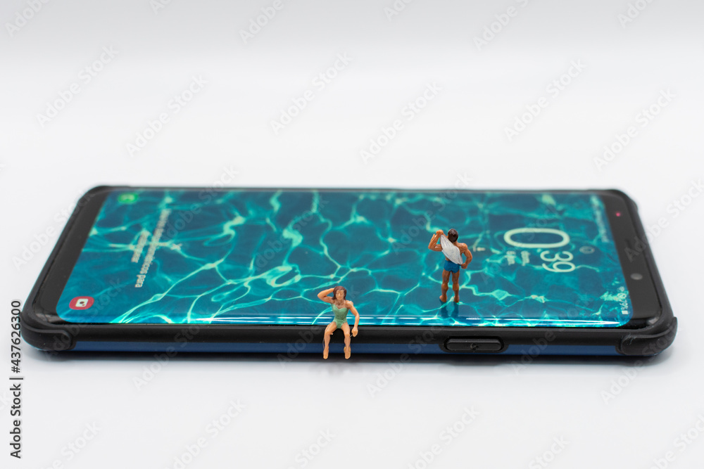 Miniature people on a smartphone with a water screensaver Miniature people on a smartphone with a water screensaver