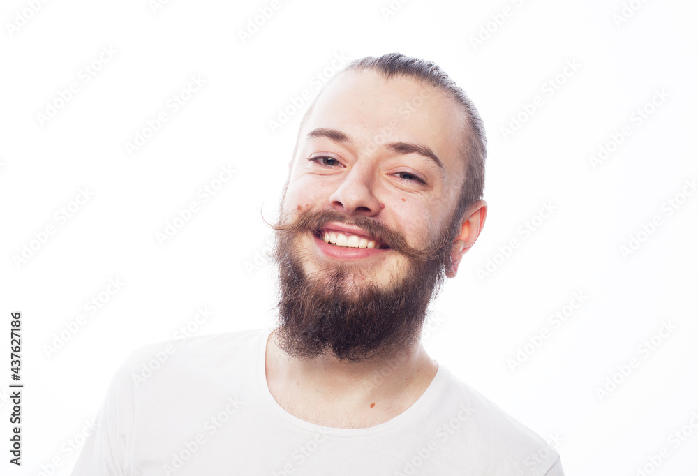Handsome young man in white t-shirt looking at camera and smiling , over white background Handsome young man in white t-shirt looking at camera and smiling , over white background