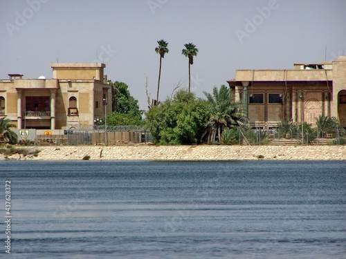 Buildings on the bank of a tributary of the Shatt Al-Arab River flowing through a Palace converted to a military base in Basra, Iraq photo