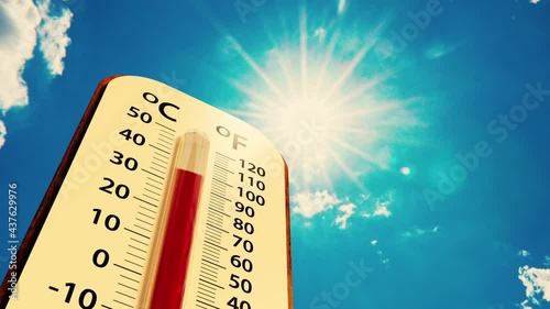 low angle view Thermometer on blue sky with sun shining in summer show higher Weather, concept global warming photo