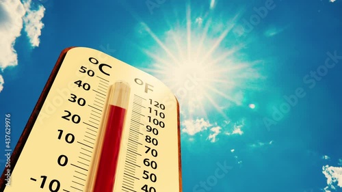 low angle view Thermometer on blue sky with sun shining in summer show higher Weather, concept global warming