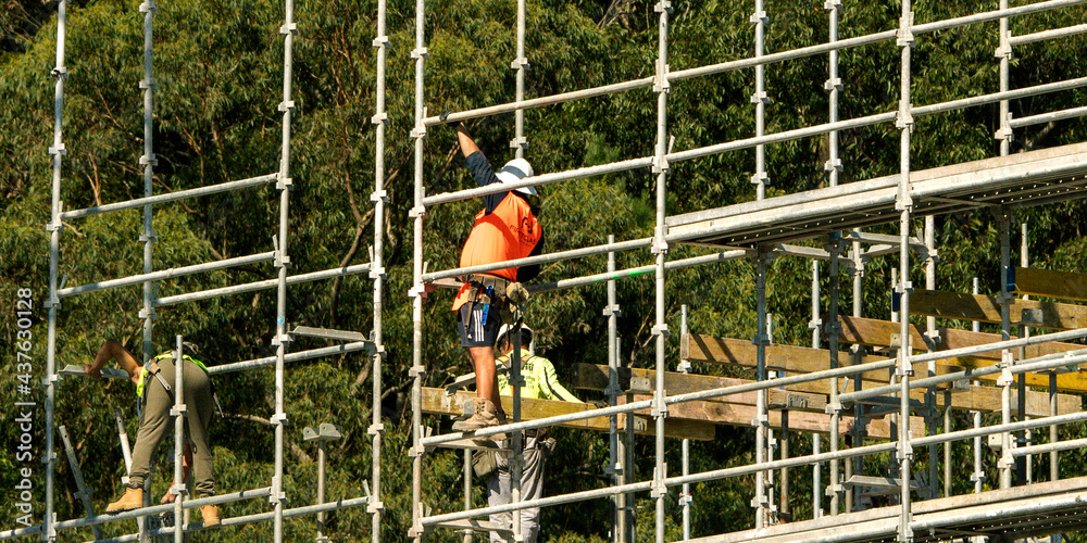 Fototapeta premium Installing scaffolding and flooring concrete formwork. Construction progress on new building site at 56-58 Beane St. Gosford, Australia. April 19, 2021.Part of a series.