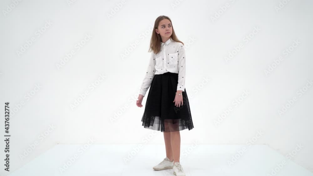 A cheerful little girl is dancing.The concept of a school of dance. A cheerful little girl is dancing.The concept of a school of dance.