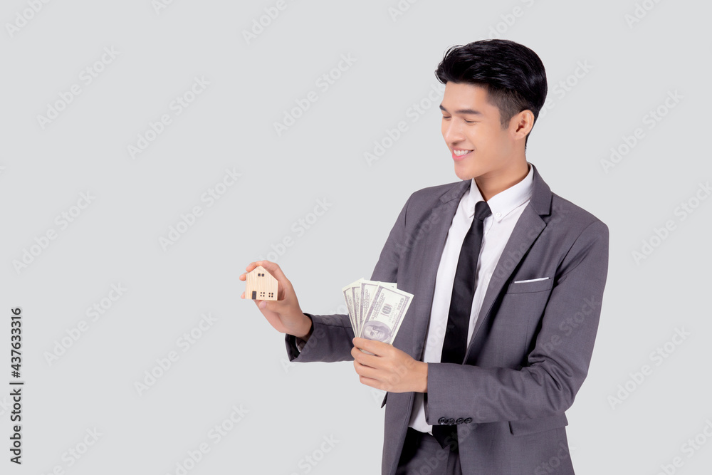 Young asian business man holding home and money dollar for saving for future, insurance agent and credit, debt and loan of finance, purchase home and refinance, investment about real property. Young asian business man holding home and money dollar for saving for future, insurance agent and credit, debt and loan of finance, purchase home and refinance, investment about real property.