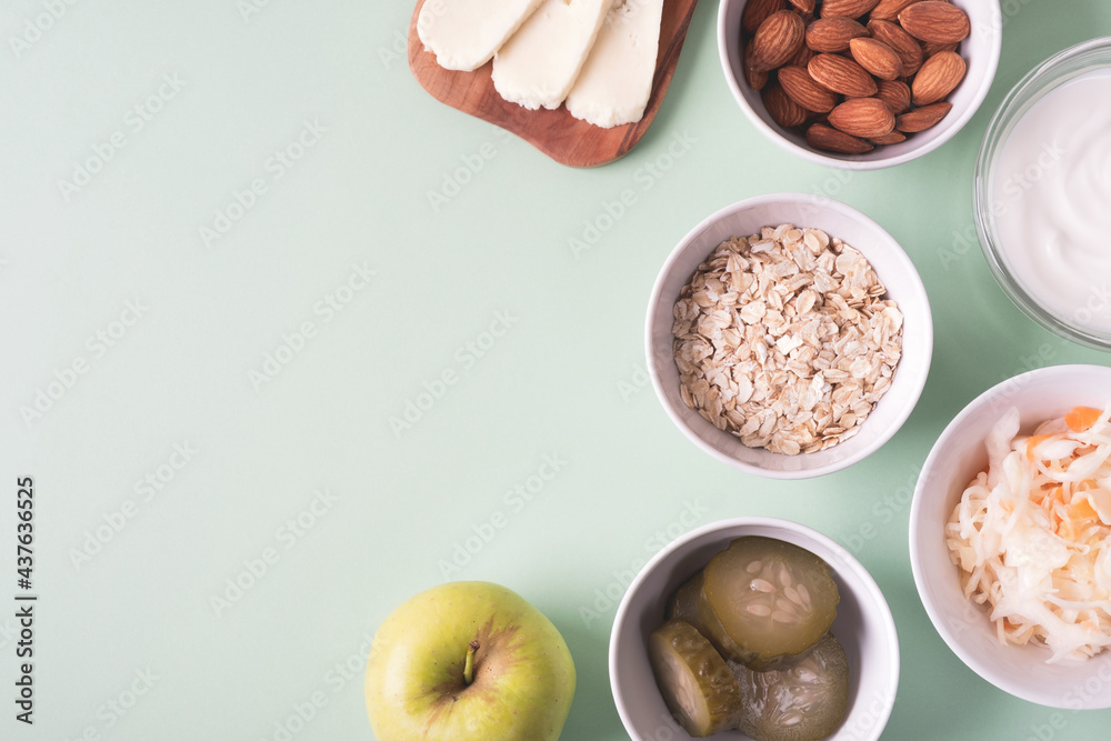 Probiotics food on light green background. Sauerkraut, pickled