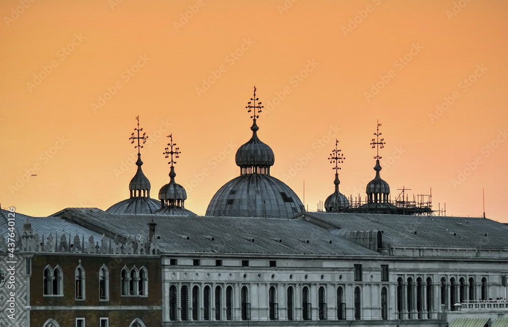 Roof and steeples silhouettes against sunset sky. Venice. Italy 