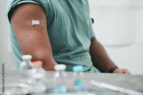 black man wearing protective mask Show plaster on the shoulder After vaccination against covid-19  health care guidelines   health protection  the impact of vaccines