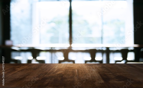 Empty wooden table in front of abstract blurred background of coffee shop . can be used for display Mock up of product