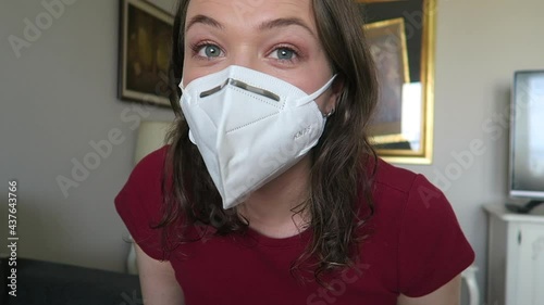 Young attractive woman trying on white and black face masks