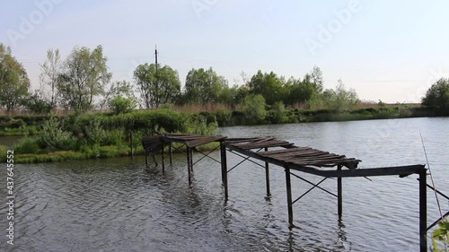 Old and abandoned lake bridge. Broken old bridge across the lake