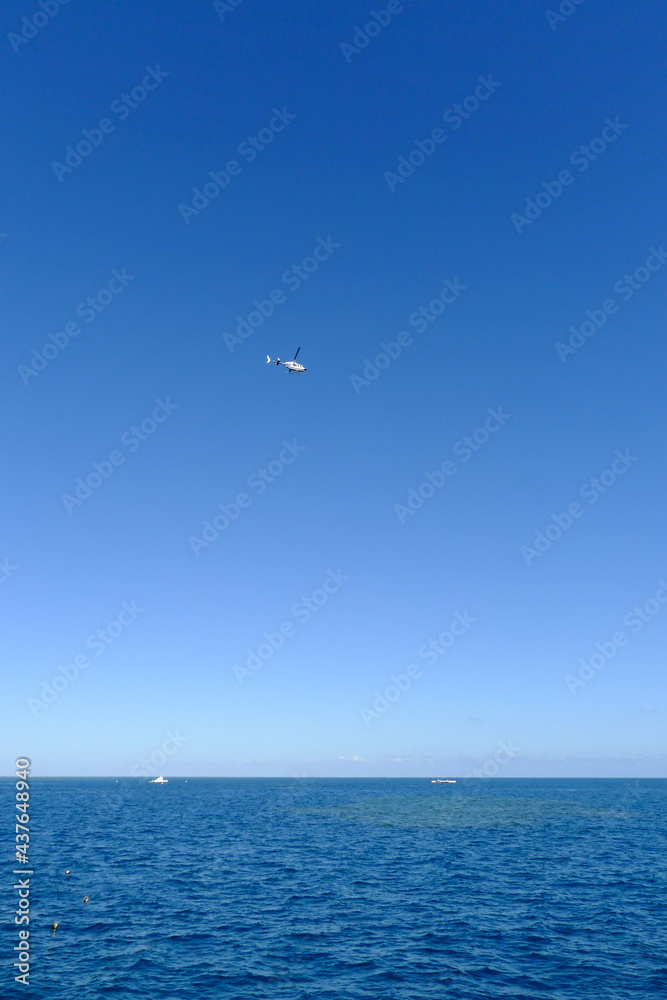 helicopter flying over the sea helicopter flying over the sea