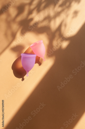 Menstrual cups minimalistic sunny image flat lay top view background with copy space photo