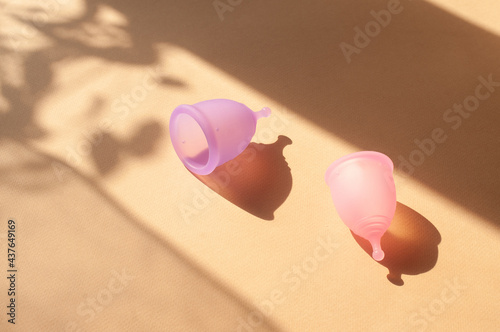 Menstrual cups minimalistic sunny image flat lay top view background with copy space photo