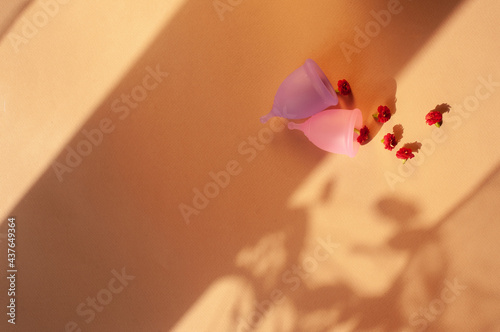 Menstrual cups minimalistic sunny image flat lay top view background with copy space photo