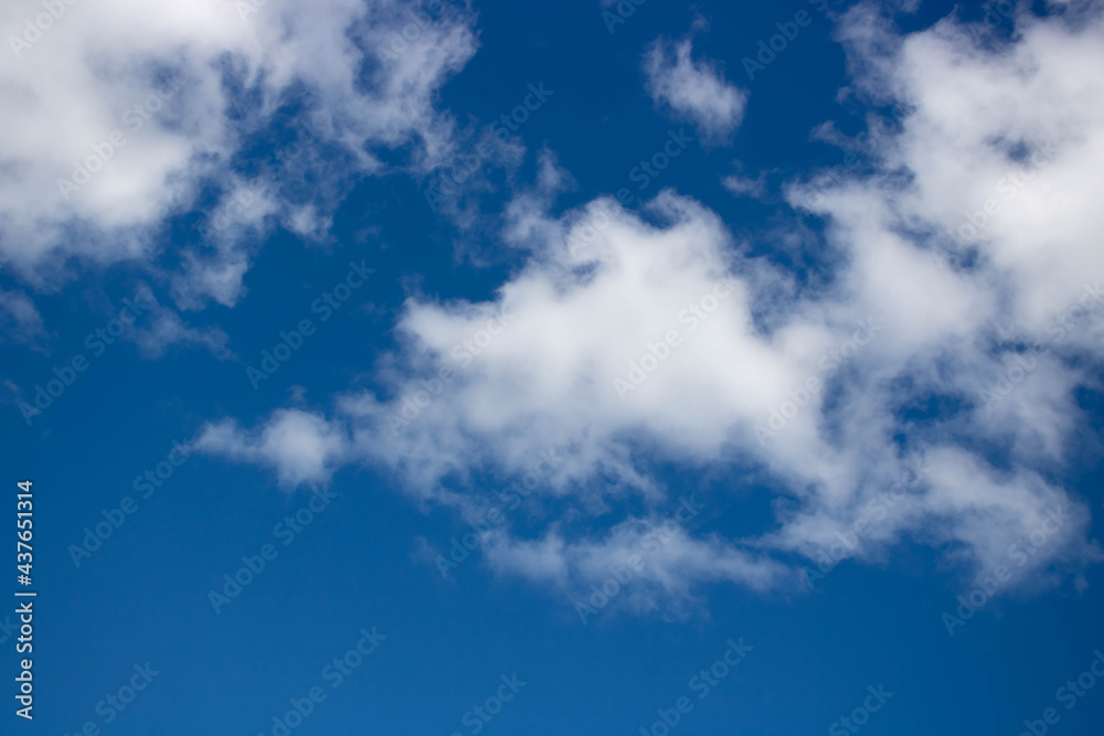 Beautiful sky background. Oddly shaped clouds in a blue sky