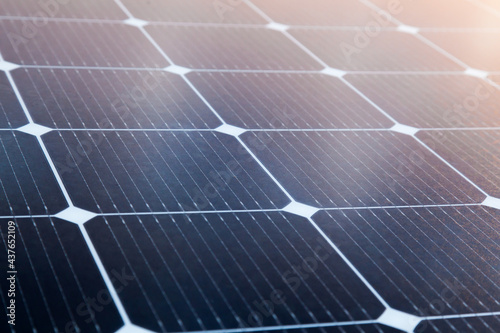Photos Solar panel close-up with the rays of the setting sun in the corner