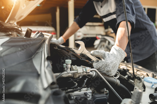 Automobile mechanic repairman hands repairing a car engine automotive workshop with a wrench, car service and maintenance,Repair service.