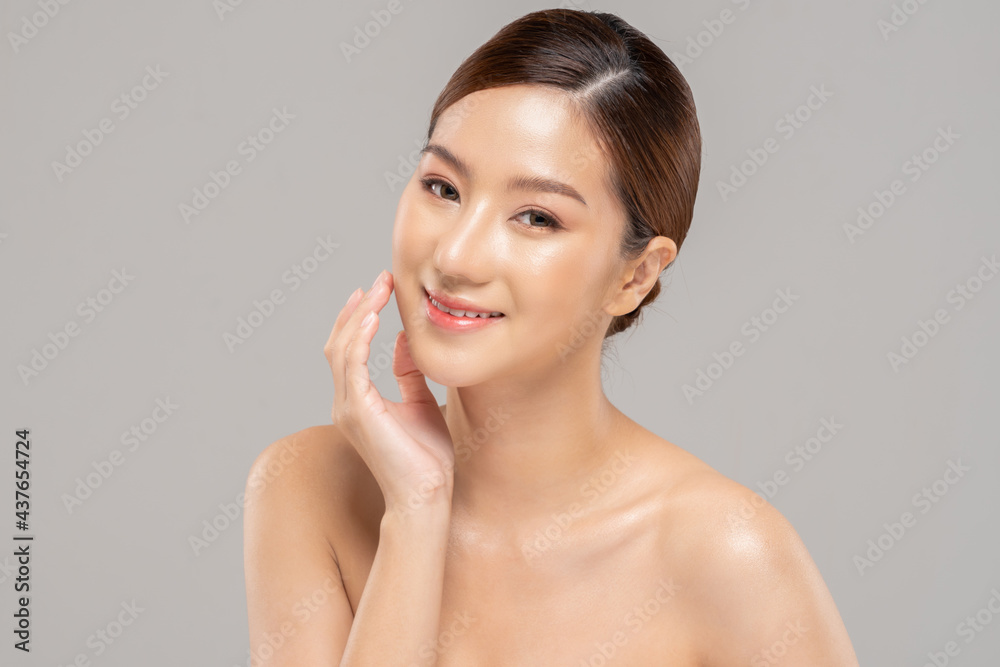 Wellness Asian young woman touch her cheek clean fresh and nutural pure skin,Pretty girl smile be moist skin on face shining like a model,Facial treatment of beauty woman,isolated on gray background Wellness Asian young woman touch her cheek clean fresh and nutural pure skin,Pretty girl smile be moist skin on face shining like a model,Facial treatment of beauty woman,isolated on gray background