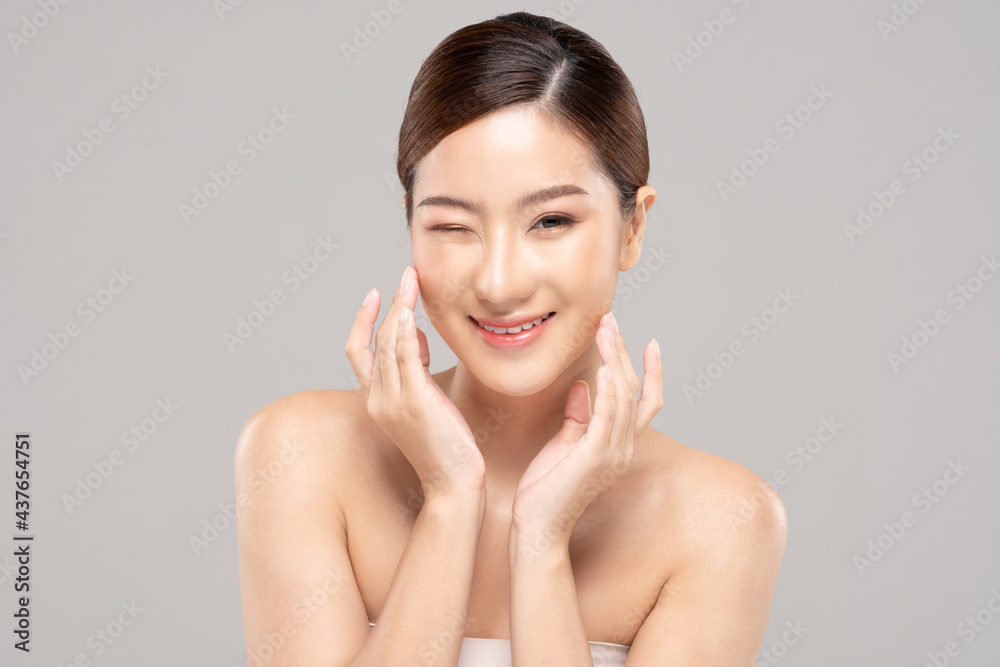 Wellness Asian young woman touch her cheek clean fresh and nutural pure skin,Pretty girl smile be moist skin on face shining like a model,Facial treatment of beauty woman,isolated on gray background Wellness Asian young woman touch her cheek clean fresh and nutural pure skin,Pretty girl smile be moist skin on face shining like a model,Facial treatment of beauty woman,isolated on gray background
