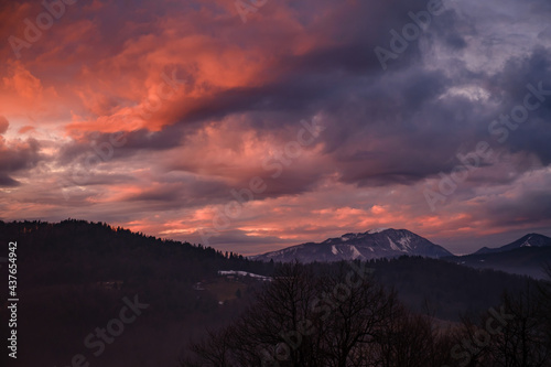 Dramatic orange sunset above Blegos hill in Slovenia