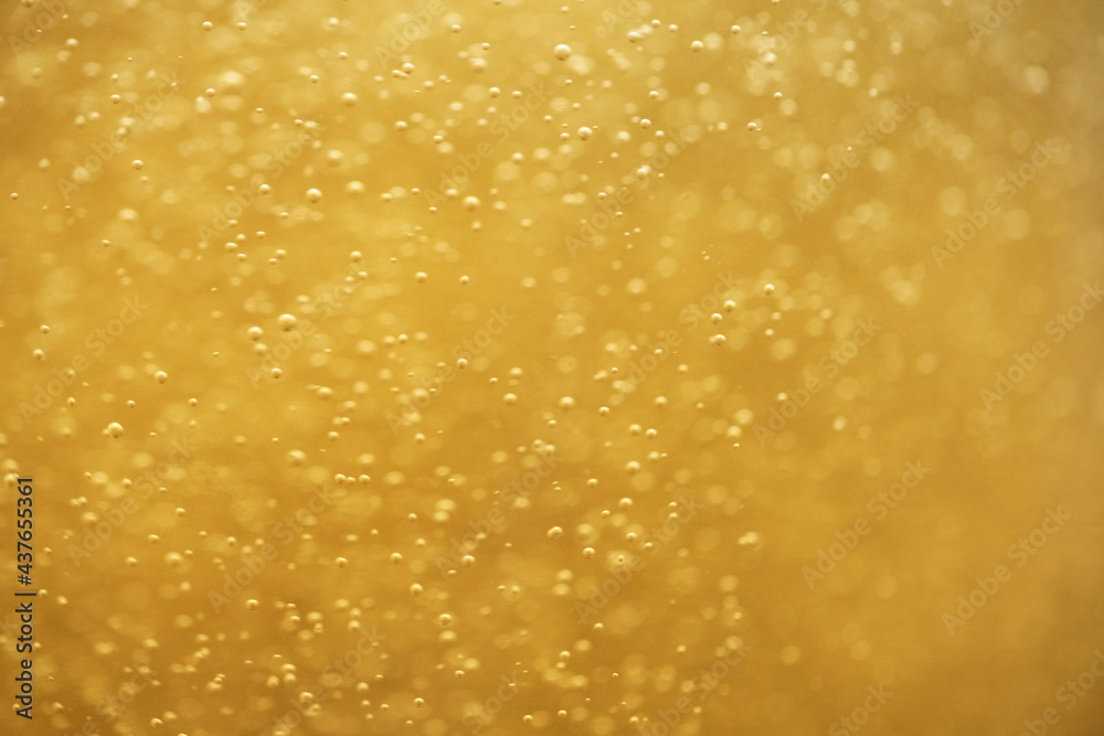 Close up motion blur texture of beer bubbles