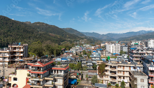 Cityscape of Pokhara with the Annapurna mountain range covered in snow at central Nepal, Asia