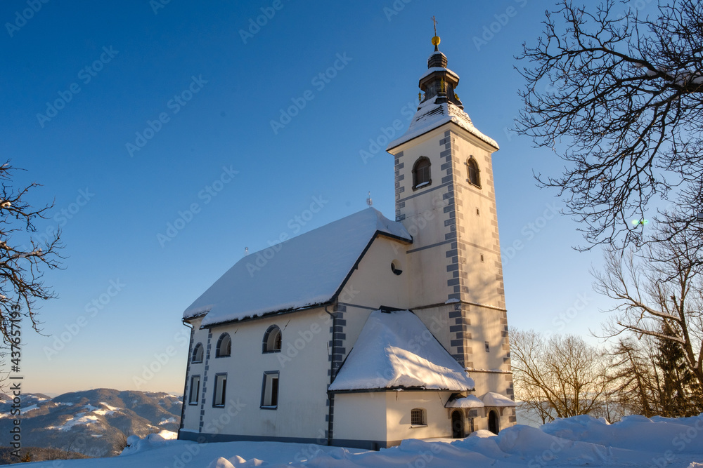 Gora or Malenski vrh mountain with church in Slovenia in winter