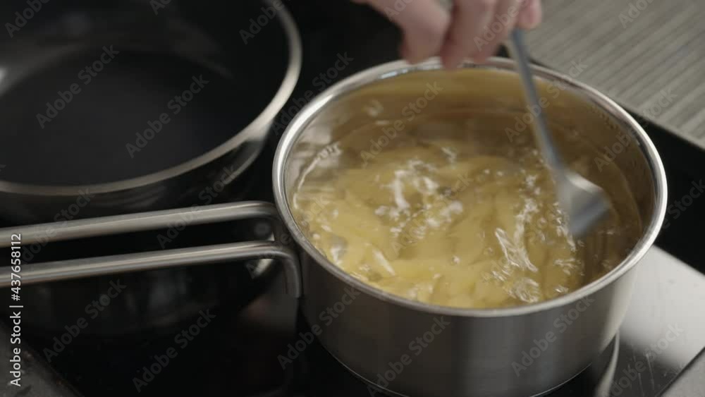 stir penne pasta into boiling water in saucepan stir penne pasta into boiling water in saucepan