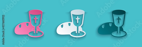 Paper cut Goblet and bread icon isolated on blue background. Bread and wine cup. Holy communion sign. Paper art style. Vector