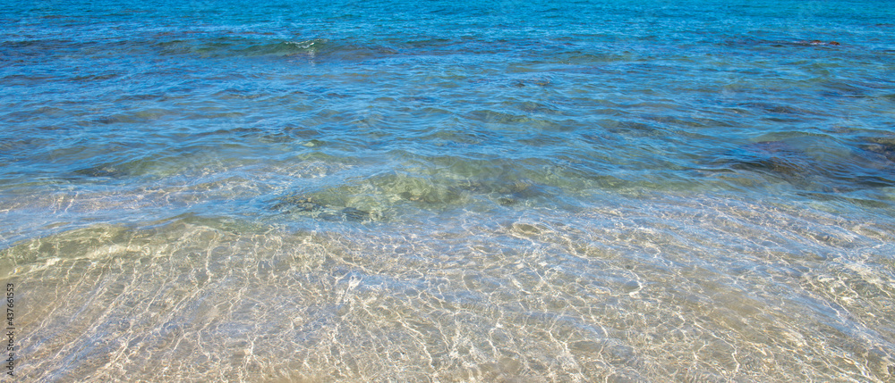 Summer sea background. Texture of water surface. Shining blue water ripple pattern.