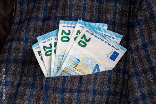 jacket pocket coming out of 20 euro bills